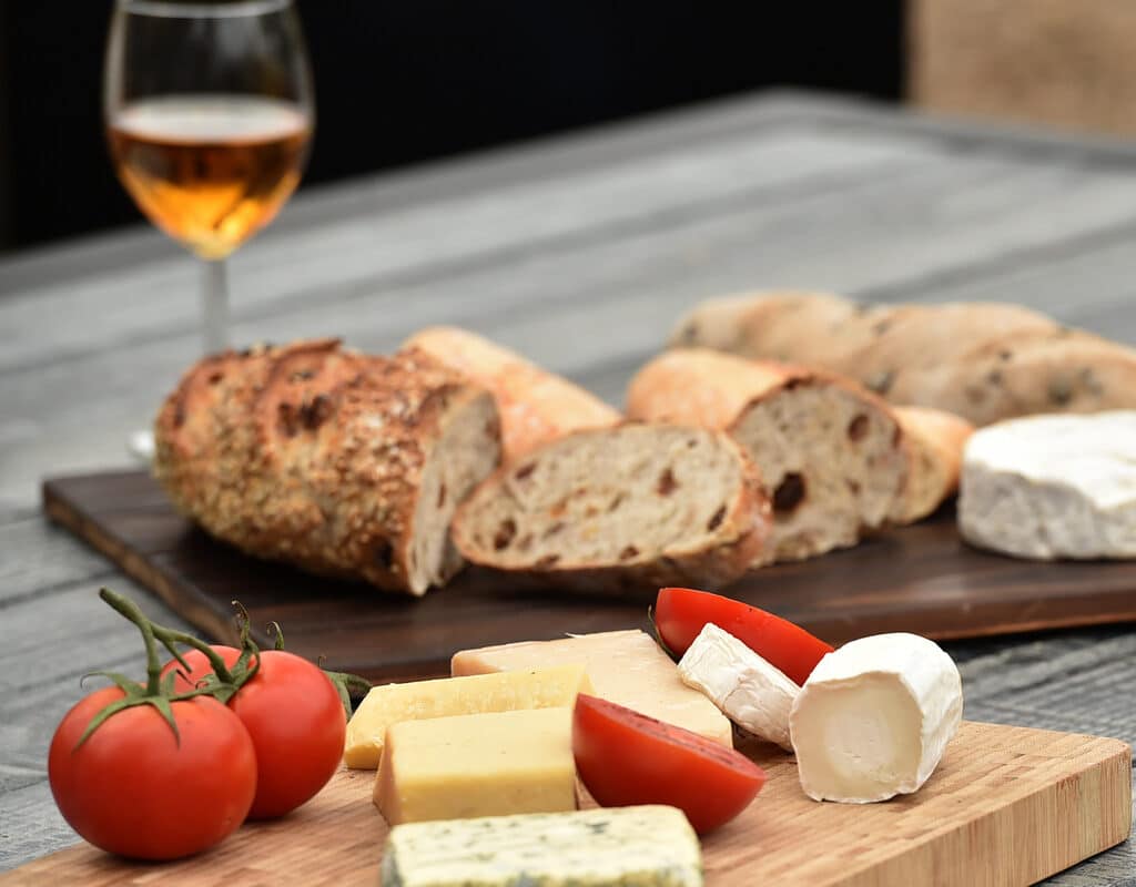 Garden table set with cheese and wine