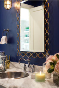 Blue wall with gold mirror