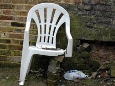 Broken white plastic chair