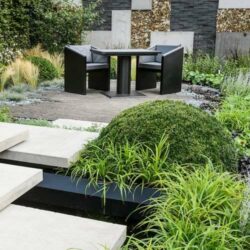 Ironfire Furniture's Bistro table presented in a landscaped garden
